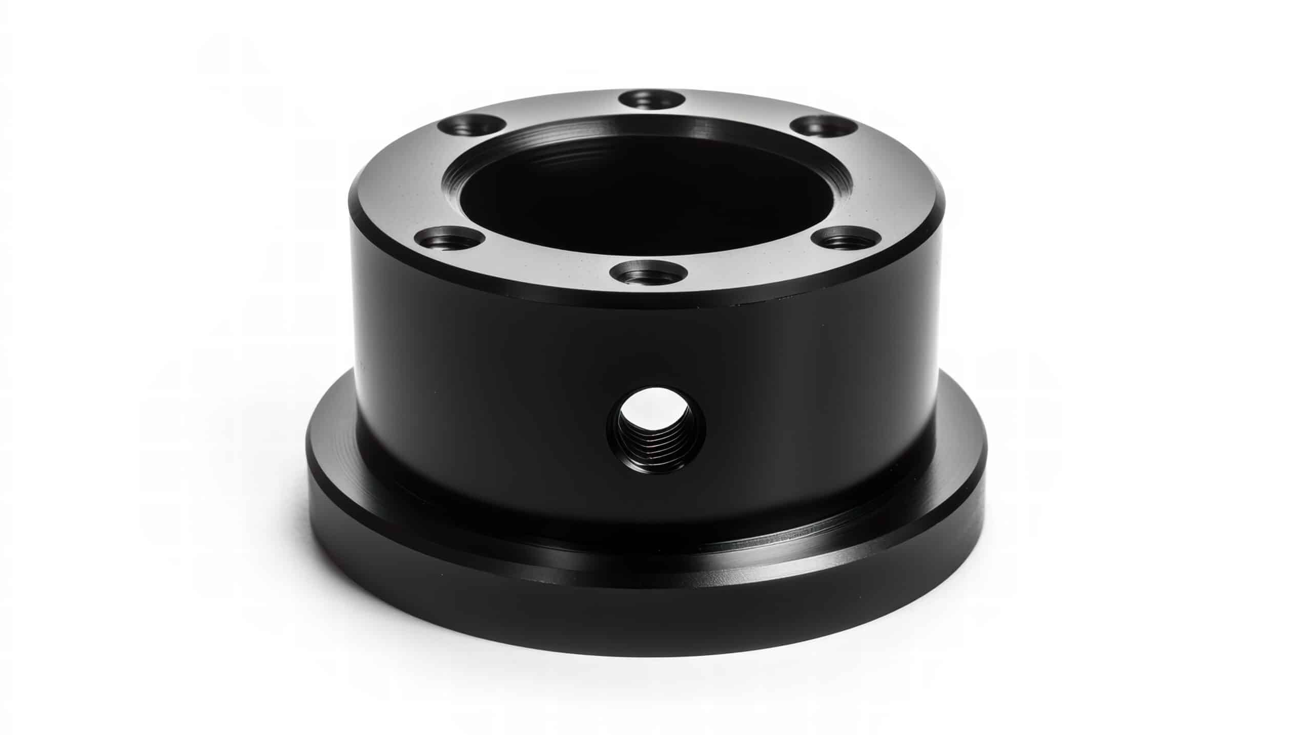 Black anodized aluminum adapter: Precision-machined black anodized aluminum adapter, featuring multiple mounting holes and a central bore. Ideal for various industrial and mechanical applications. Rapid Turnaround, Superior Quality Anodizing